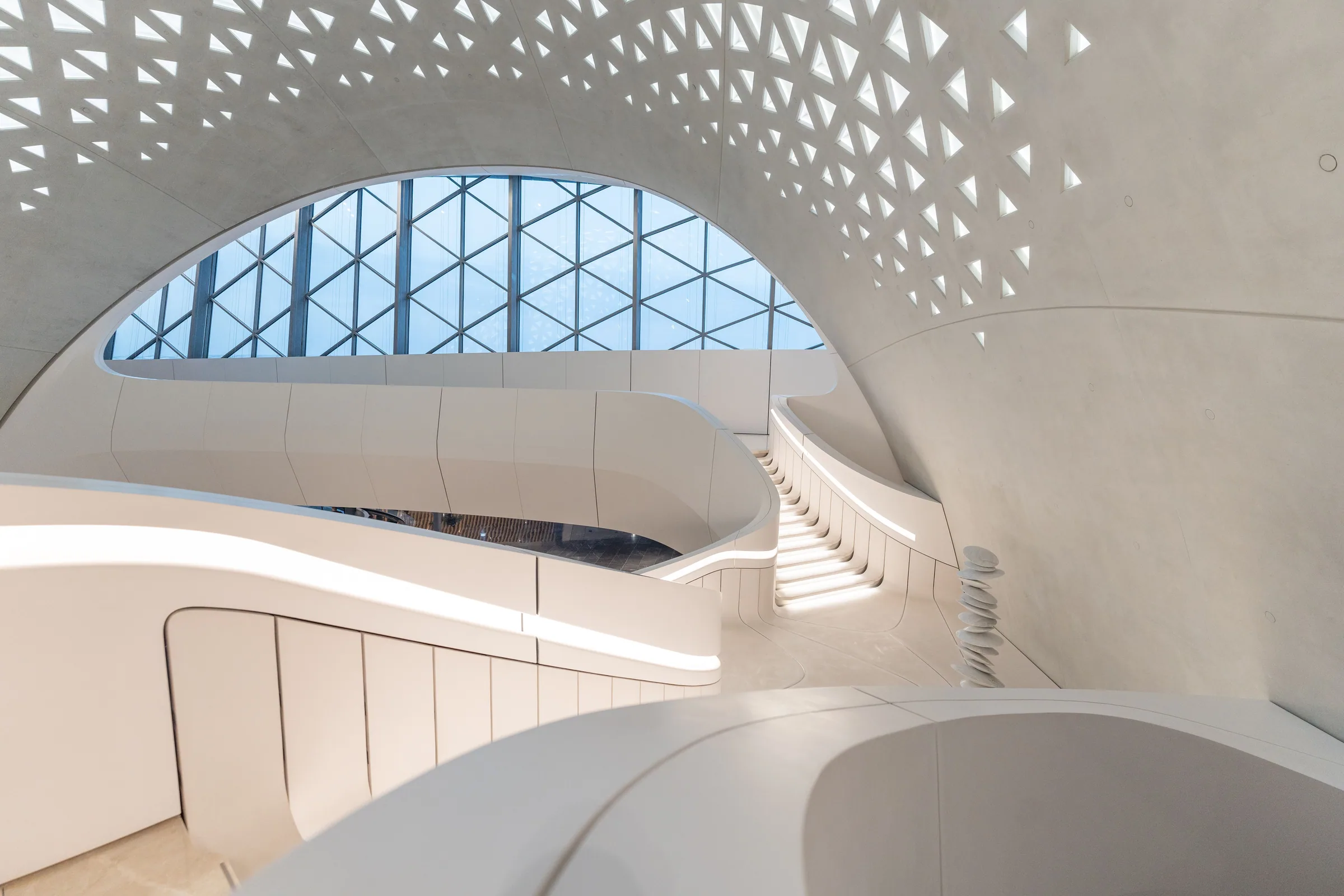 Sculptural curved staircase in a bright contemporary interior